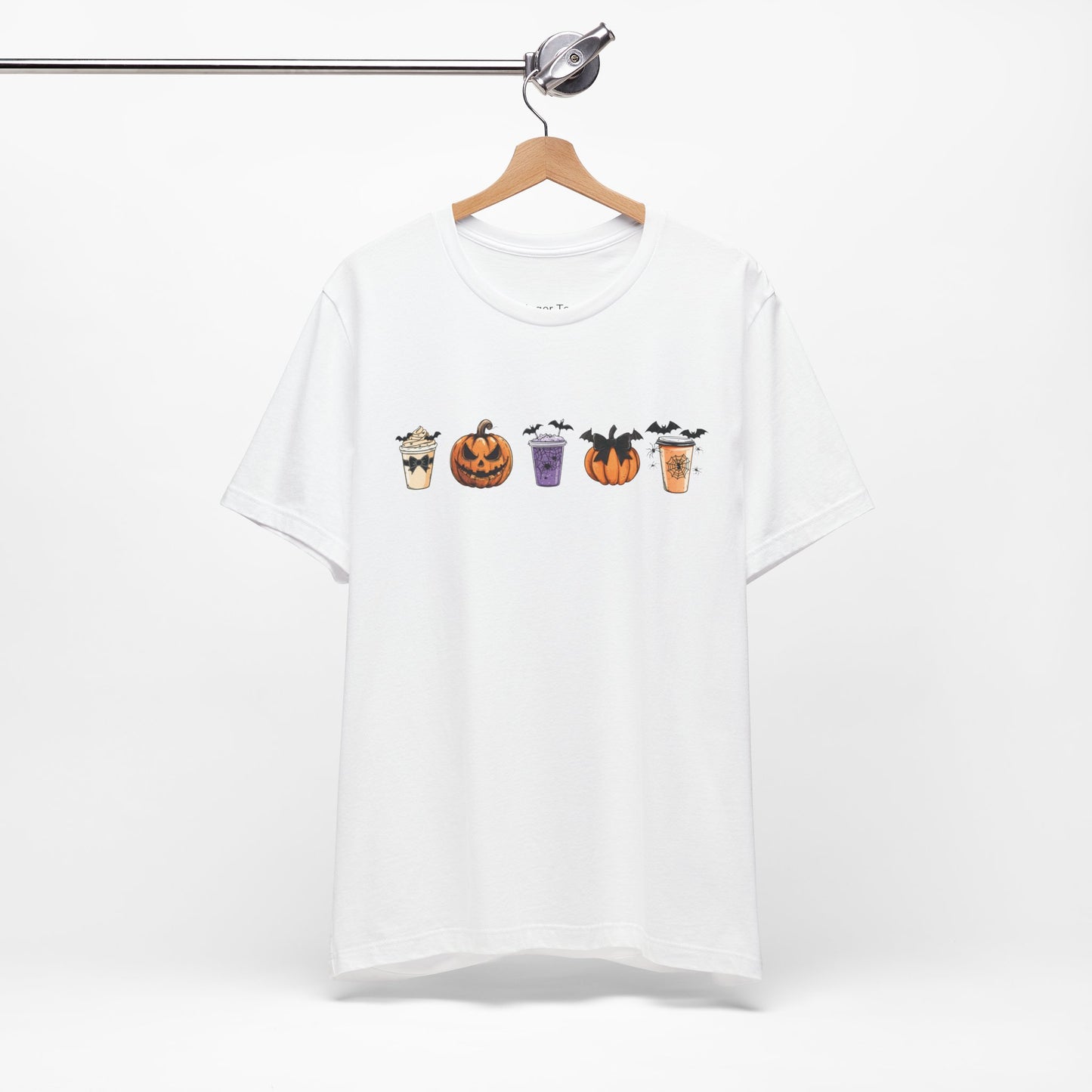 white t-shirt featuring five Halloween-themed coffee cups and pumpkins with bats, perfect for coffee lovers and Halloween enthusiasts seeking a fun, spooky vibe.