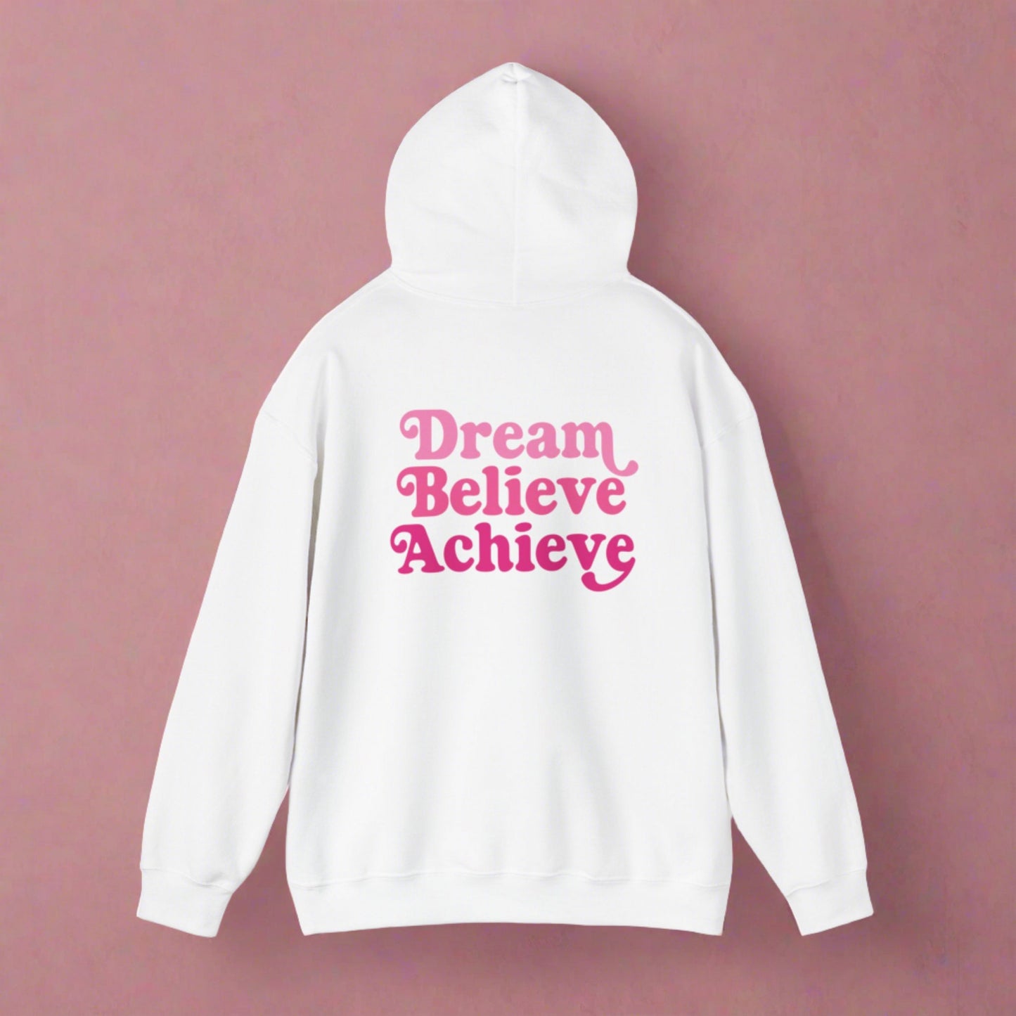 White hooded sweatshirt with 'Dream Believe Achieve' written in three shades of pink font. Empowerment, Aspirational Clothing Style and Motivation