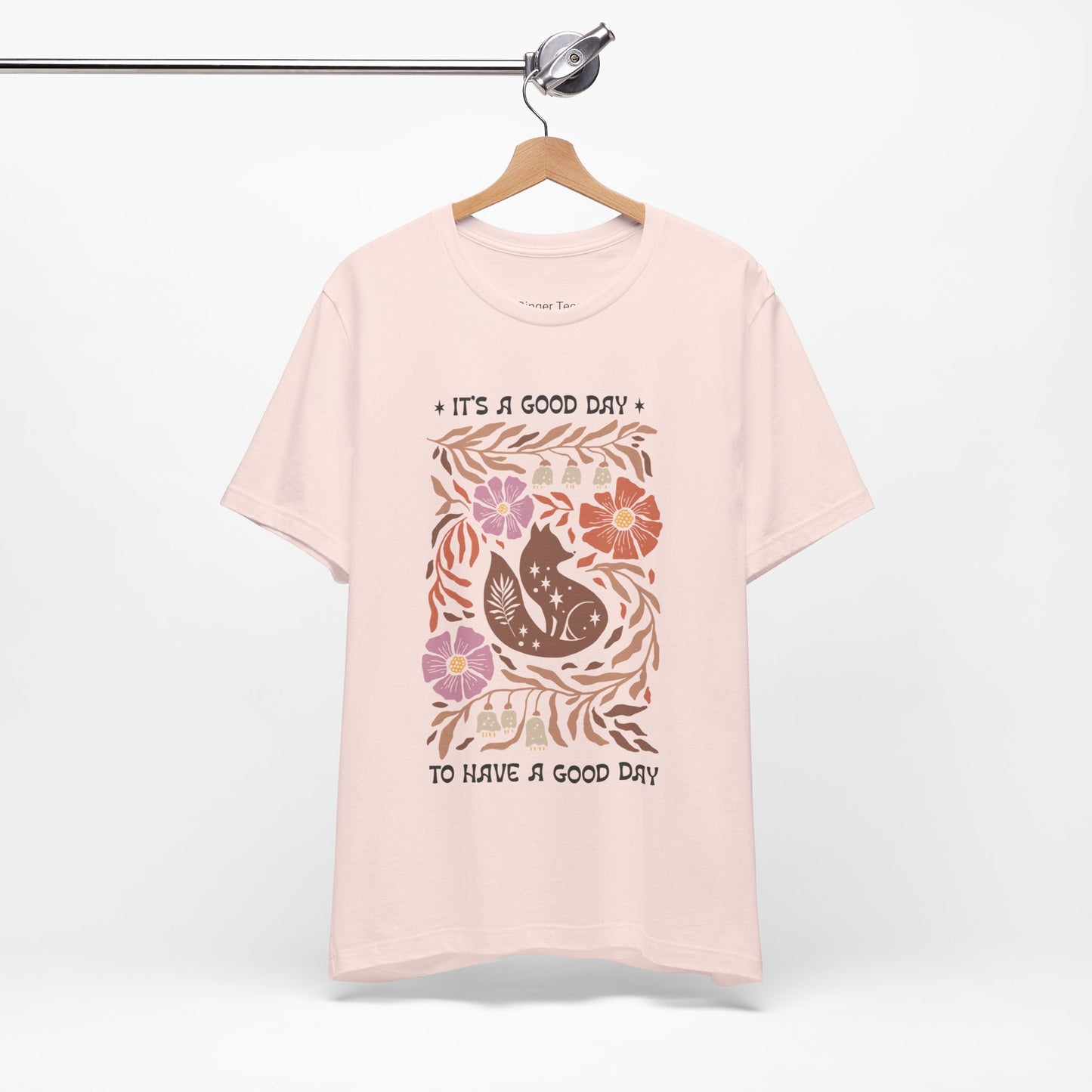 Boho-inspired t-shirt featuring the phrase 'It's a Good Day, to have a good day' in a retro, playful font, perfect for those who love positive vibes and carefree, stylish designs. Available in soft, earthy tones