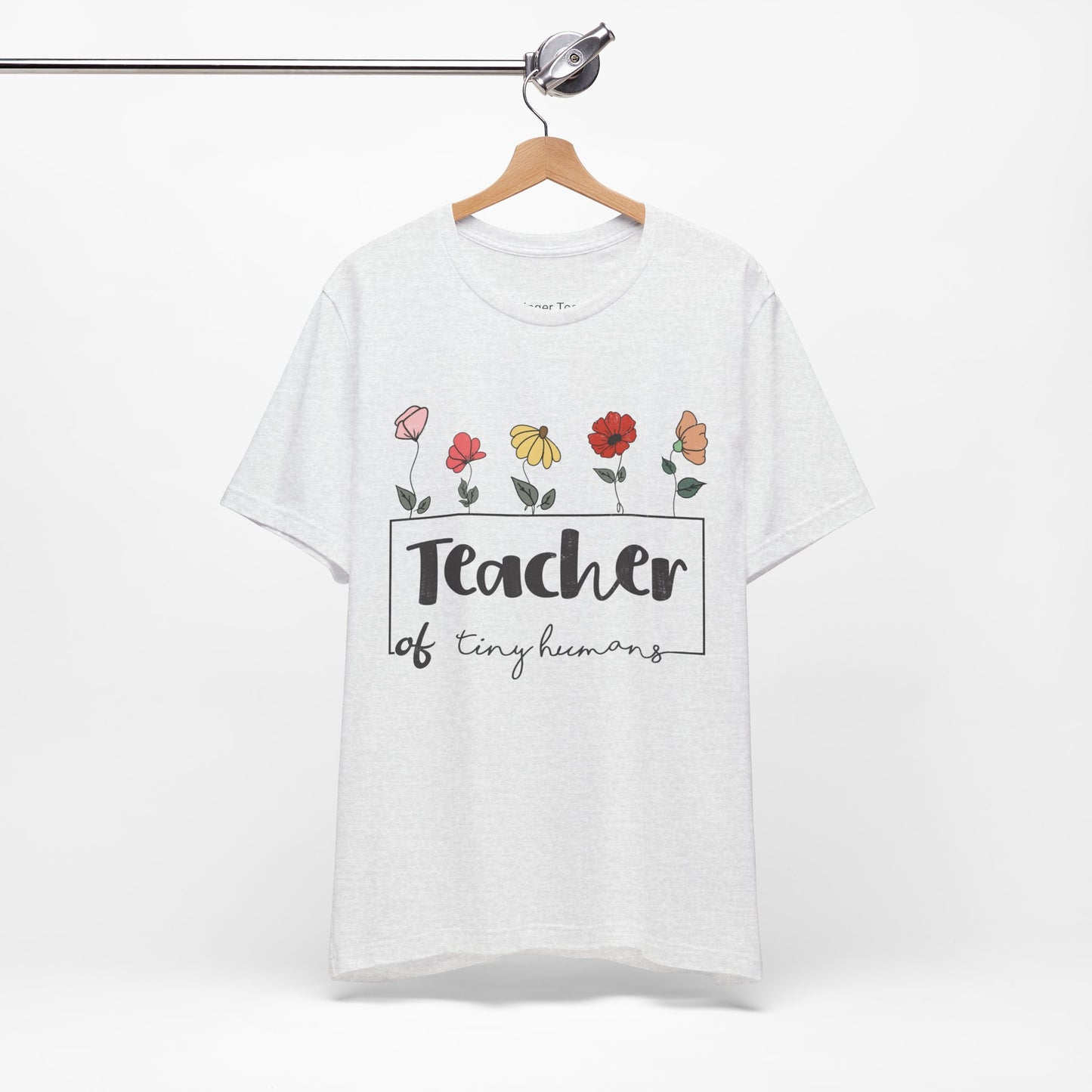 Express your passion for teaching with this sweet t-shirt embellished with floral designs.
