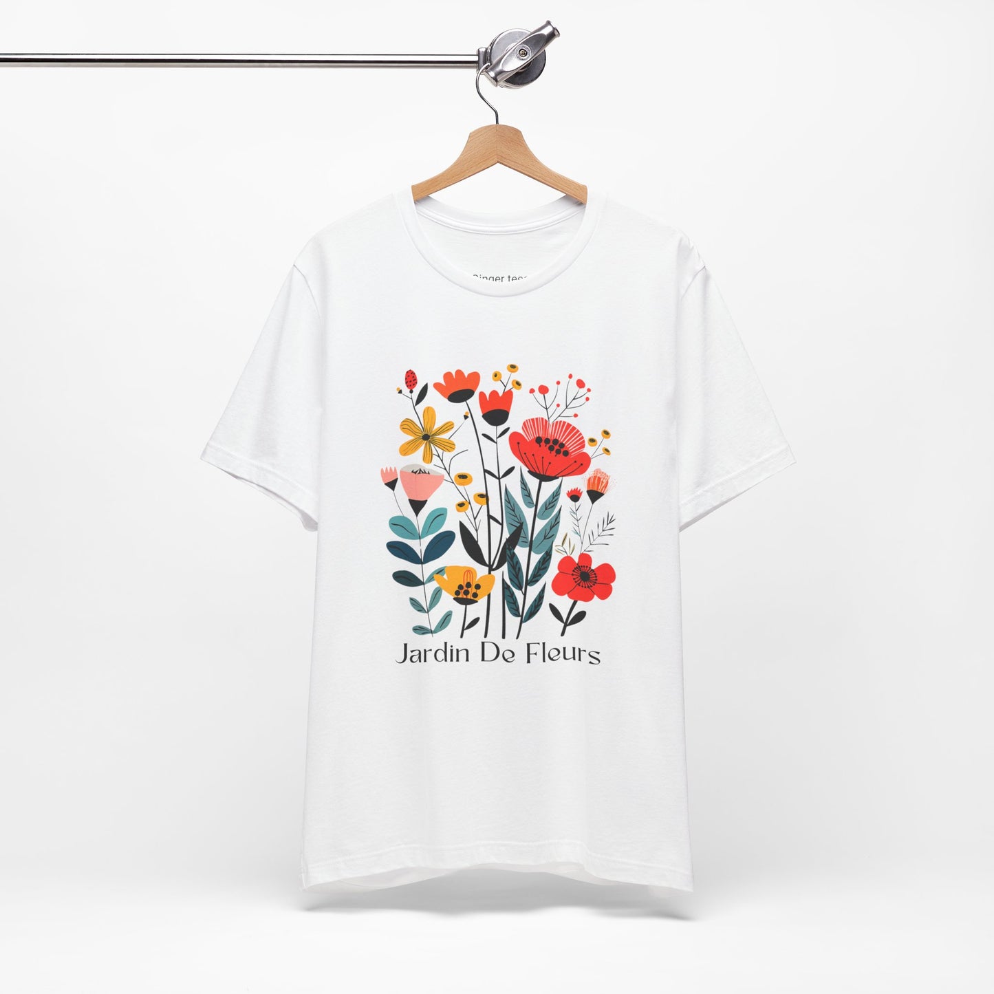 White t-shirt with a colorful floral design and the text 'Jardin De Fleurs' at the bottom. The design features various flowers in red, orange, yellow, and pink hues with green leaves, creating a vibrant garden look.