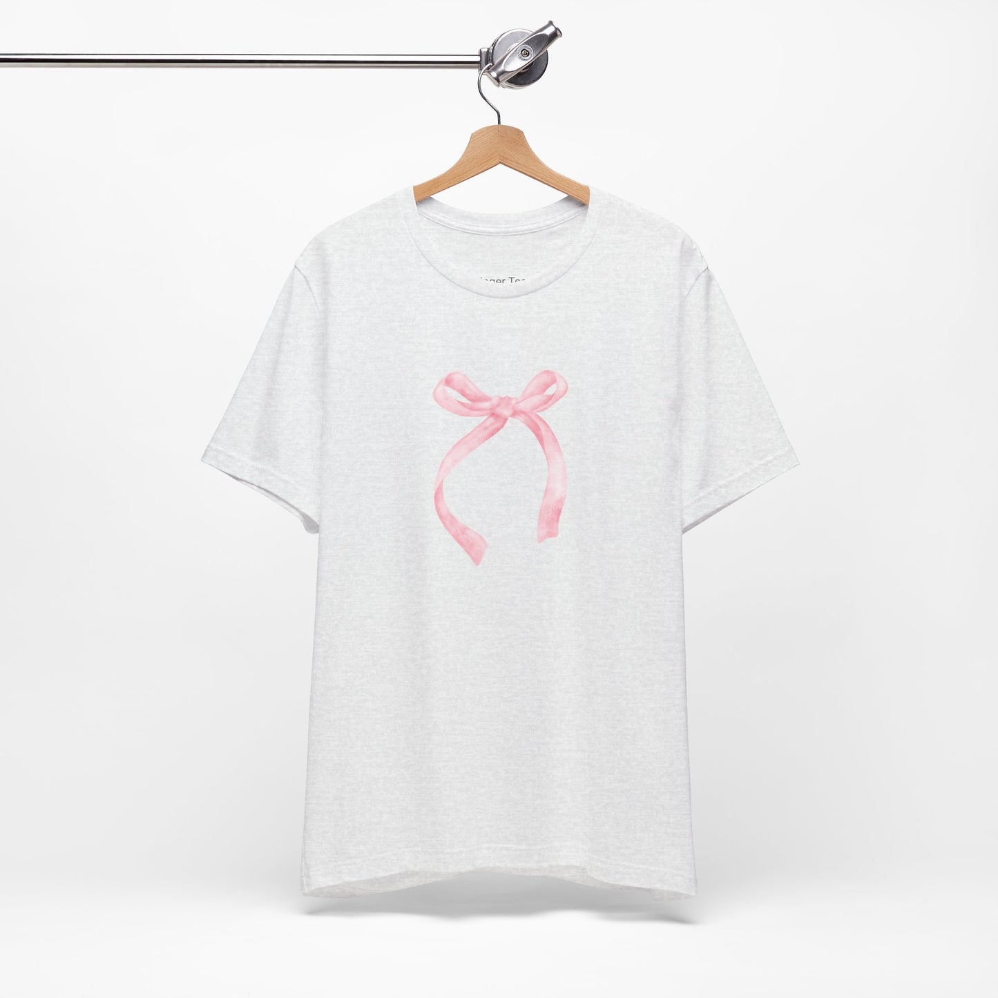 Stylish coquette-inspired t-shirt embellished with a soft pink bow for a playful yet sophisticated look.