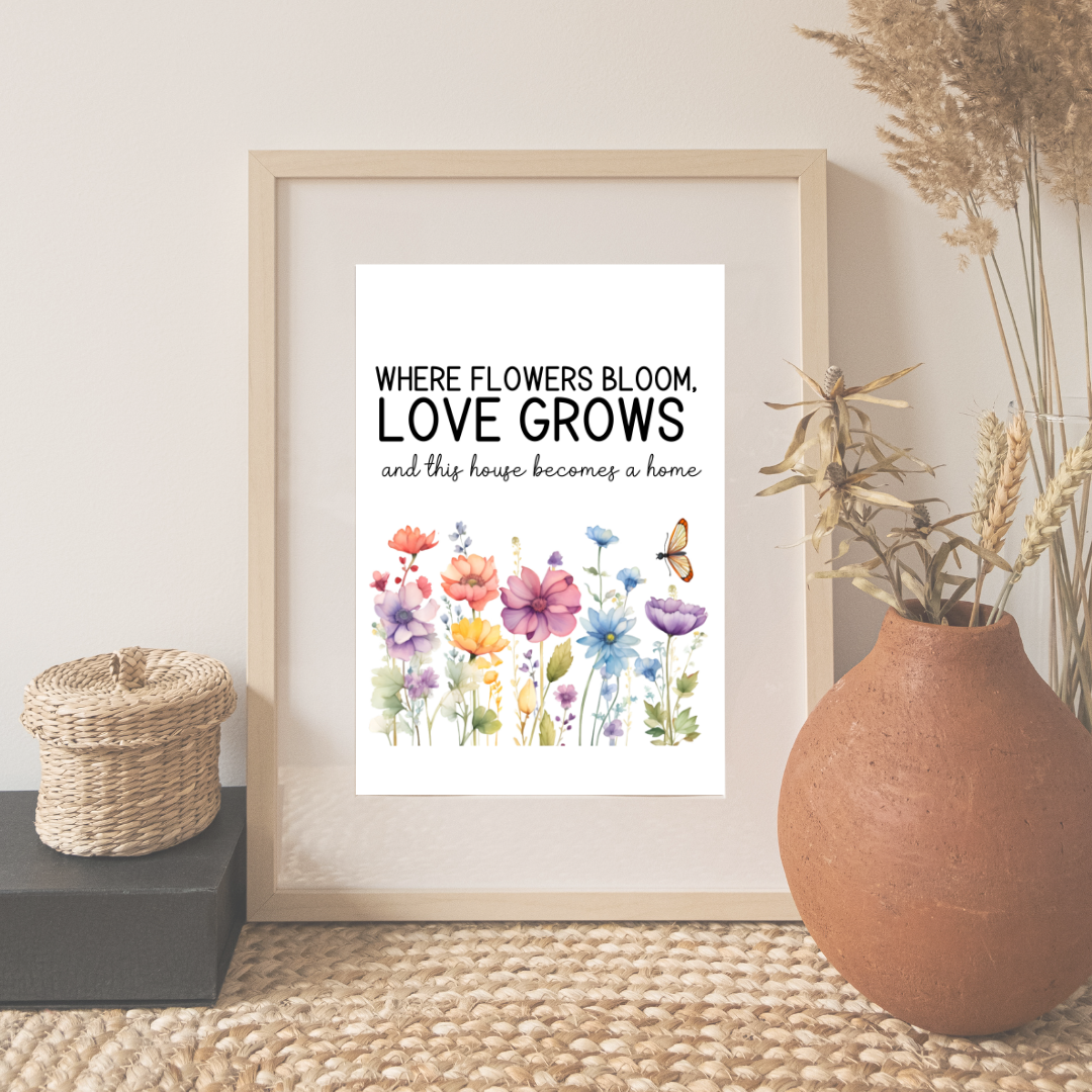 A printable wall art design featuring the quote 'Where flowers bloom, love grows – and this house becomes a home,' surrounded by colorful wildflowers and a butterfly. Perfect for adding warmth and charm to any home decor.