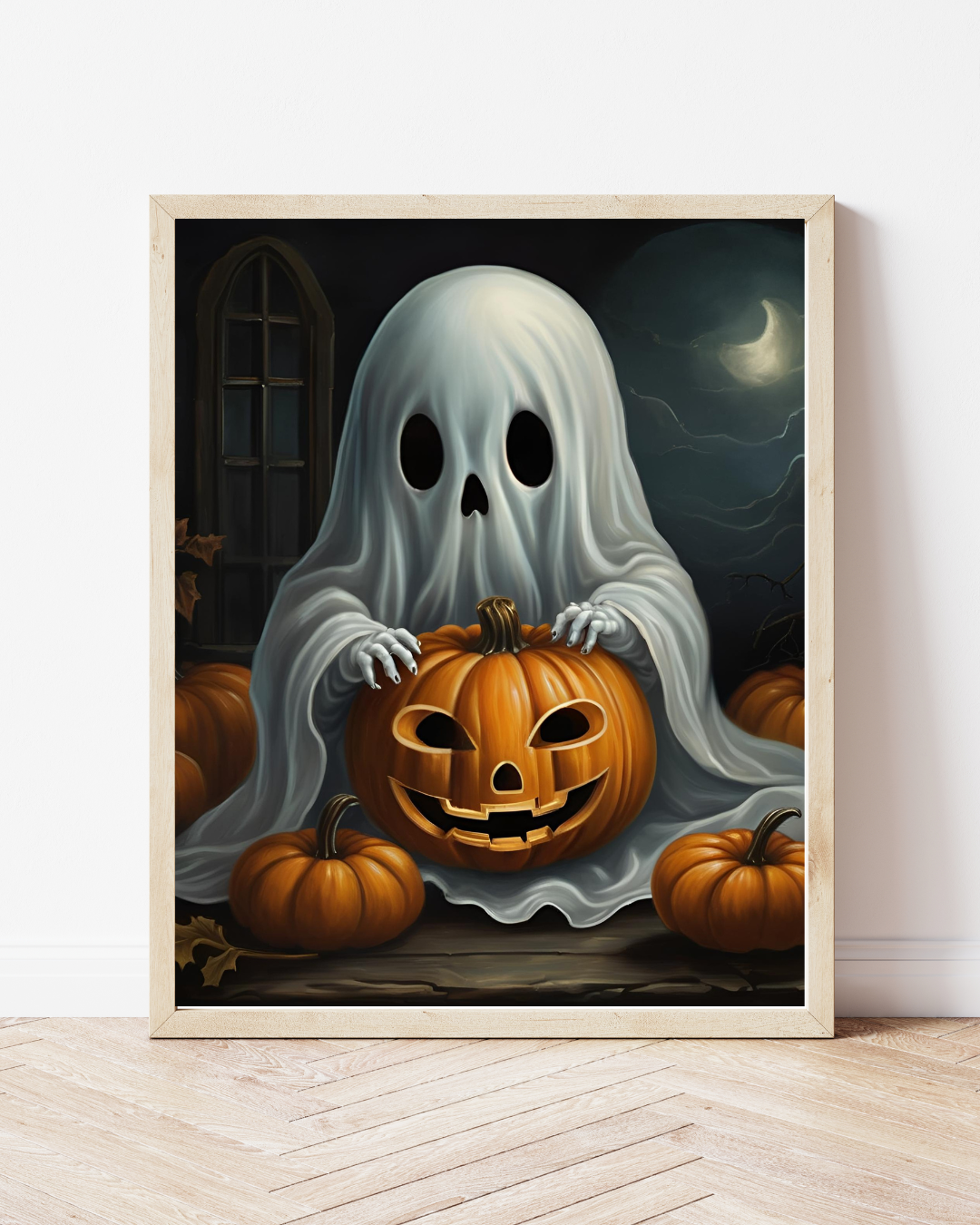 A digital printable wall art featuring a classic ghost in a white sheet with black eyes, cradling a carved jack-o'-lantern and surrounded by pumpkins, displayed in a frame.