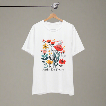 White t-shirt with a colorful floral design and the text 'Jardin De Fleurs' at the bottom. The design features various flowers in red, orange, yellow, and pink hues with green leaves, creating a vibrant garden look.