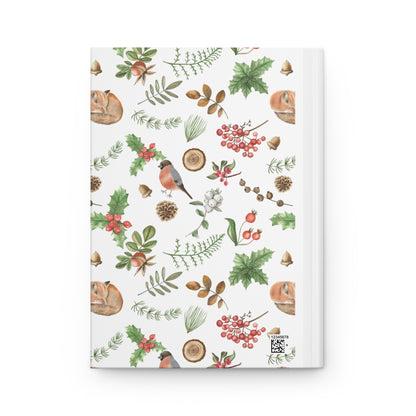 journal cover with a delicate watercolor pattern of woodland plants, berries, and a sleeping chipmunk, alongside holly leaves, pinecones, and a bullfinch bird on a white background.
