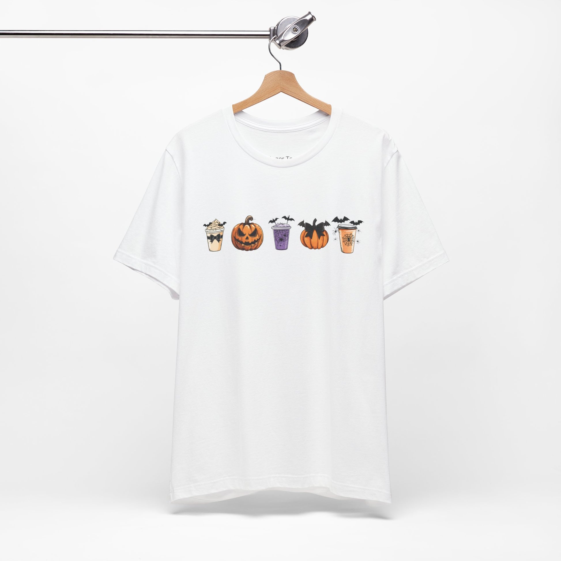 white t-shirt featuring five Halloween-themed coffee cups and pumpkins with bats, perfect for coffee lovers and Halloween enthusiasts seeking a fun, spooky vibe.