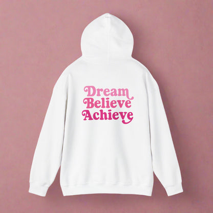 White hooded sweatshirt with 'Dream Believe Achieve' written in three shades of pink font. Empowerment, Aspirational Clothing Style and Motivation