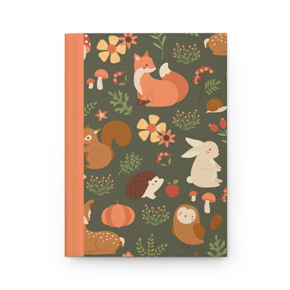 journal cover featuring adorable illustrations of forest animals like squirrels, foxes, and owls, surrounded by trees and mushrooms in a playful, colorful design.